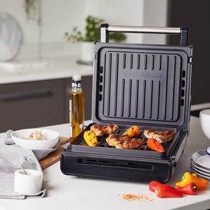 George Foreman 28000 Smokeless Electric Grill in use.