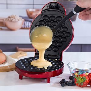 Adding batter to the Giles & Posner Bubble Waffle Maker.