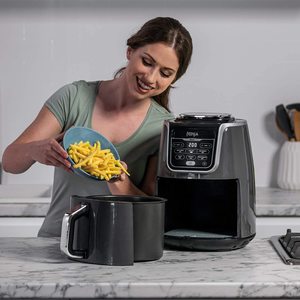 Filling the Ninja AF160UK Air Fryer.