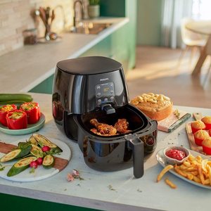 Philips Essential Air Fryer next to fried food.