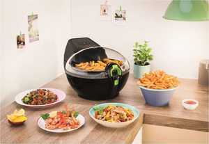 Tefal ActiFry Family Express Air Fryer next to some fried food.