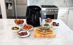 Yedi Houseware Air Fryer next to fried food.